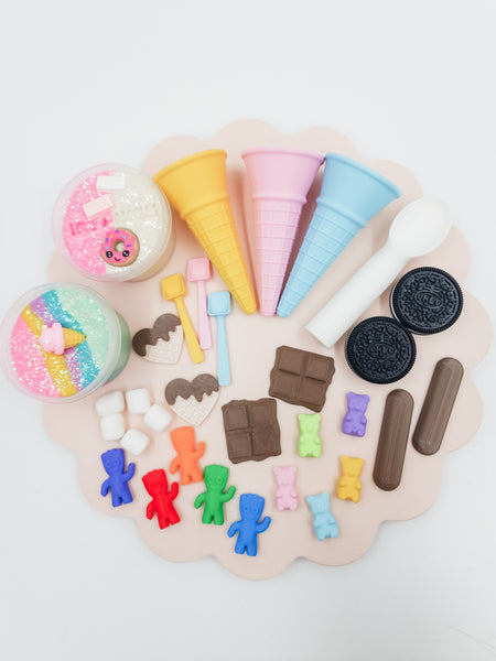 Ice Cream Parlour playdough kit with glitter dough jars, pastel ice cream cones, gummy bear figures, chocolate bar pieces, Oreo cookie moulds, and marshmallow toppers